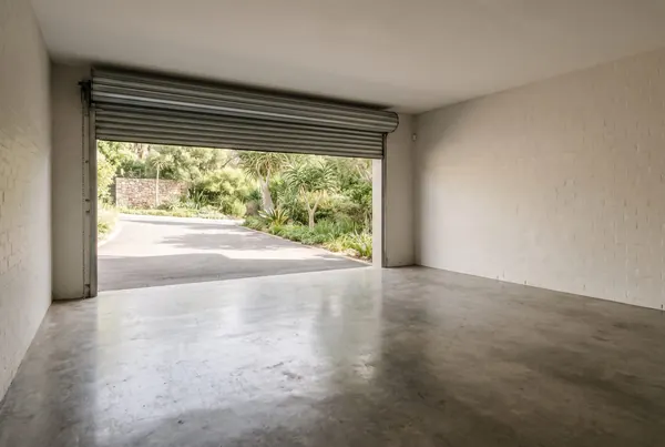 A cleared double garage in Randburg with the floor swept