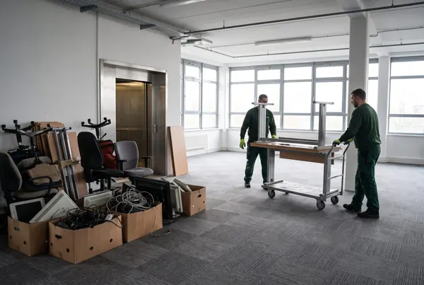 Desks and old partitioning stacked ready to leave an office park unit